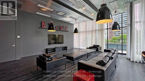 A living room with a large couch and a flat screen TV.