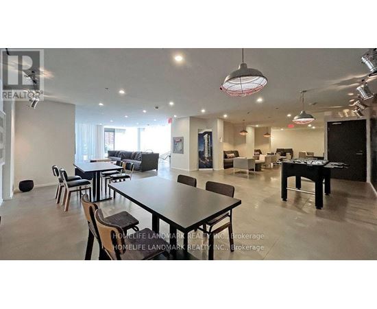 A spacious dining area with a long table and chairs.