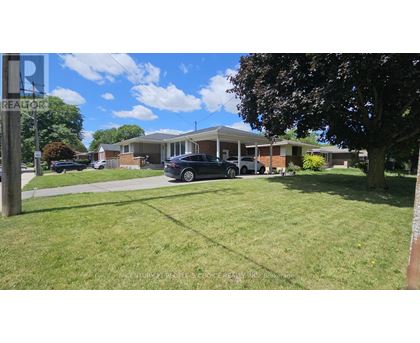 A grassy area with a sign that says REALTOR.