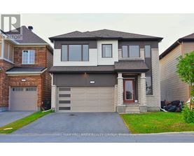A two-story house with a garage is for sale.