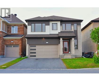 A two-story house with a garage is for sale.