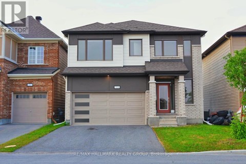 A two-story house with a garage is for sale.