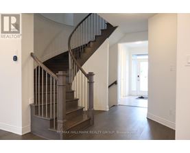 A staircase with a metal railing and wooden steps.