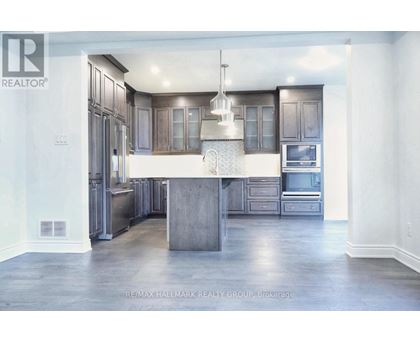 A modern kitchen with a center island and stainless steel appliances.