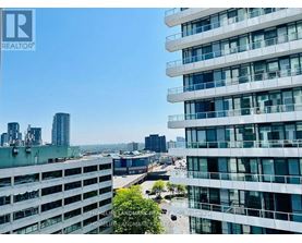 A view of a cityscape from a high-rise building with the words "REALTOR" visible on the top left corner.