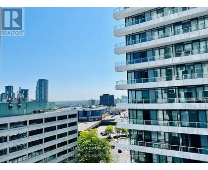 A view of a cityscape from a high-rise building with the words "REALTOR" visible on the top left corner.