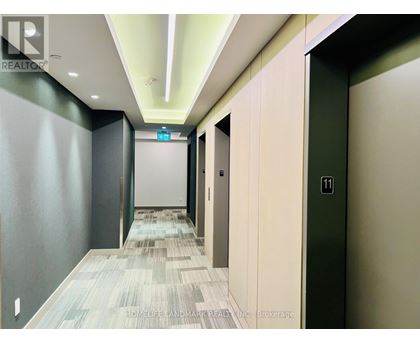 A hallway with a green door and a white door.