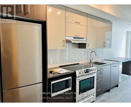A modern kitchen with stainless steel appliances and white cabinets.