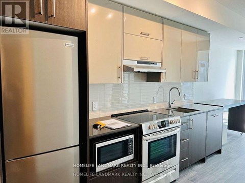 A modern kitchen with stainless steel appliances and white cabinets.