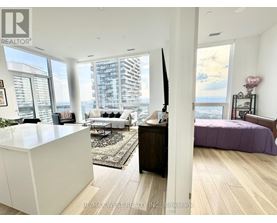 A bedroom with a purple bed and a white cabinet.
