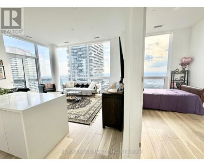 A bedroom with a purple bed and a white cabinet.