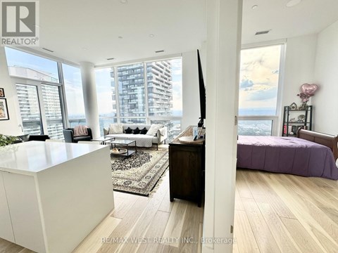 A bedroom with a purple bed and a white cabinet.