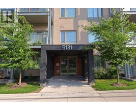 The front of apartment building number 5131 with trees on either side.