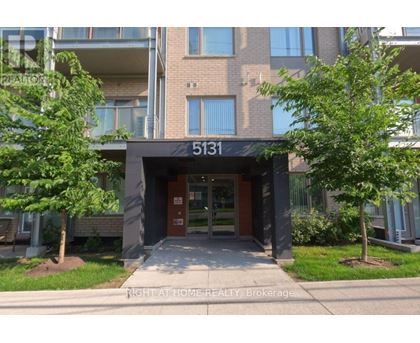 The front of apartment building number 5131 with trees on either side.
