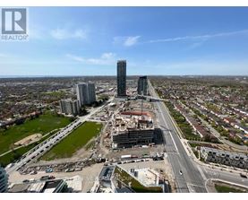 A cityscape with a clear sky and a road with multiple lanes.