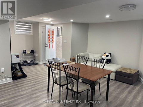 A dining room with a table and chairs.