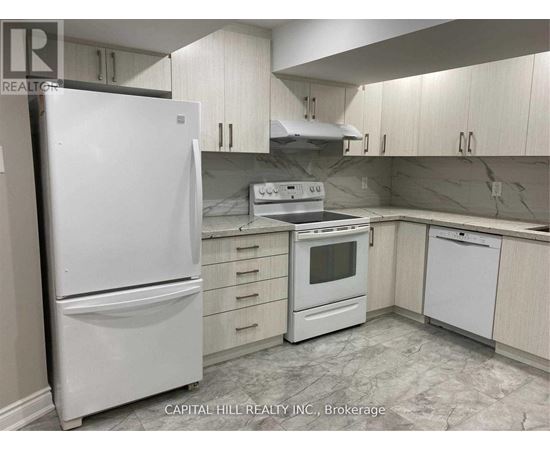 A white refrigerator stands in a kitchen with white cabinets and a marble floor.