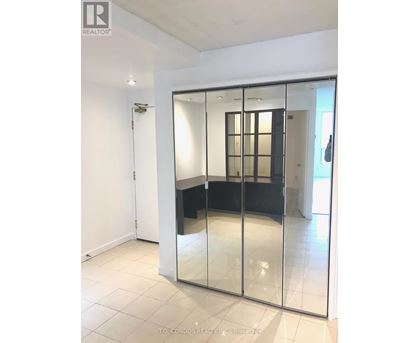 A room with a glass door and a white wall.