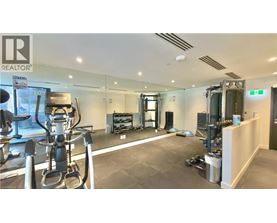 A gym with a variety of equipment including treadmills, weights, and exercise machines.