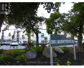 A sign for 2001 Bonnymede Dr. is in front of a building.