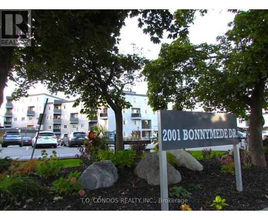 A sign for 2001 Bonnymede Dr. is in front of a building.