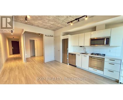 A kitchen with white cabinets and a microwave above the stove.