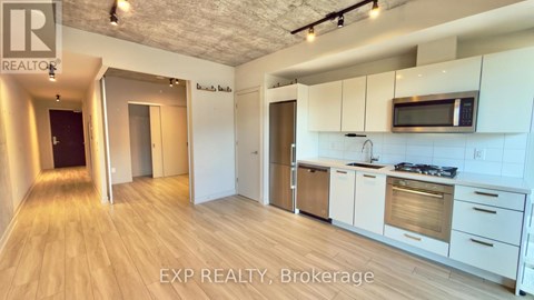 A kitchen with white cabinets and a microwave above the stove.