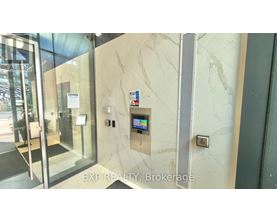 A glass door with a sign that says "EXP REALTY Brokerage" on the wall.