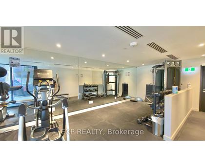 A gym with a variety of equipment including treadmills, weights, and exercise machines.