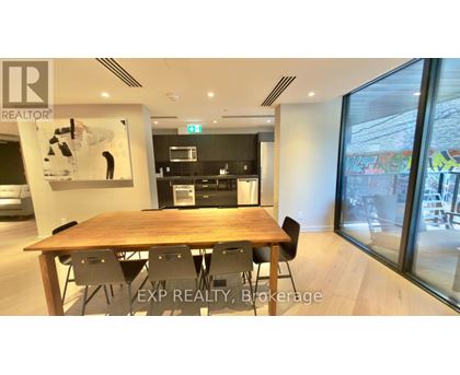 A dining room with a wooden table and chairs.
