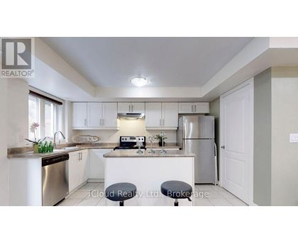 A kitchen with white cabinets and a stainless steel dishwasher.