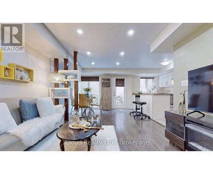 A modern living room with a white sofa and a coffee table.