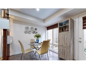 A dining room with a table set for two and a view of the backyard.