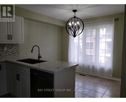 A kitchen with a sink and a chandelier.
