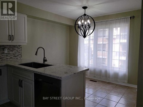 A kitchen with a sink and a chandelier.