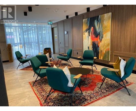 A conference room with green chairs and a large painting on the wall.