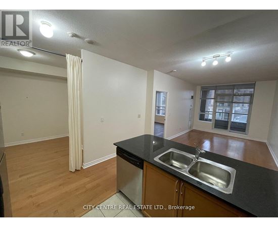 A kitchen with a sink and a window.