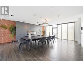 A dining room with a long table and chairs.