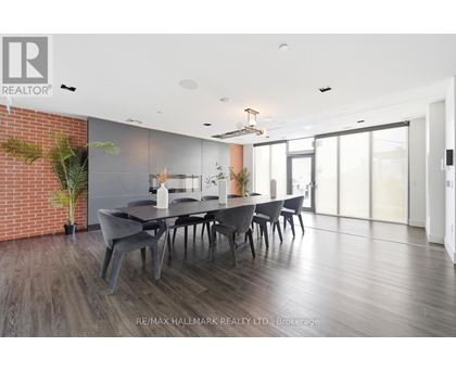 A dining room with a long table and chairs.