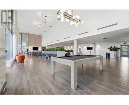 A spacious room with a pool table and a ping pong table.