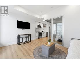 A modern living room with a flat screen TV mounted on the wall.