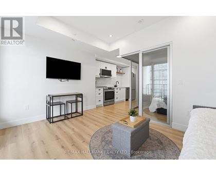 A modern living room with a flat screen TV mounted on the wall.