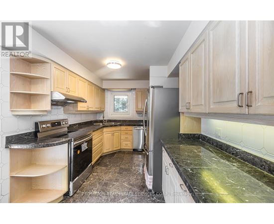 A kitchen with wooden cabinets and black appliances.