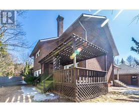 A house with a red brick exterior and a wooden deck.