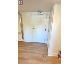 A white door with the number 9 on it is in a room with a white wall and a wooden floor.