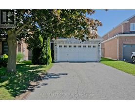 A white garage door is closed and the words "Bay Street Group Inc Brokerage" is written on the sign.