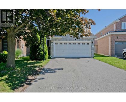 A white garage door is closed and the words "Bay Street Group Inc Brokerage" is written on the sign.
