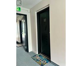 A door with a glass panel and the number 12 on it.