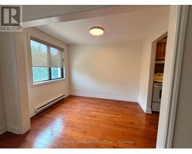 A room with wooden floors and a window.