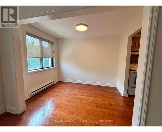 A room with wooden floors and a window.